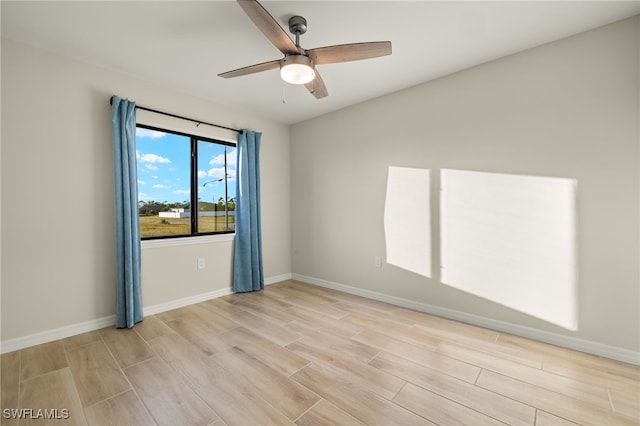 spare room featuring ceiling fan and light wood-type flooring