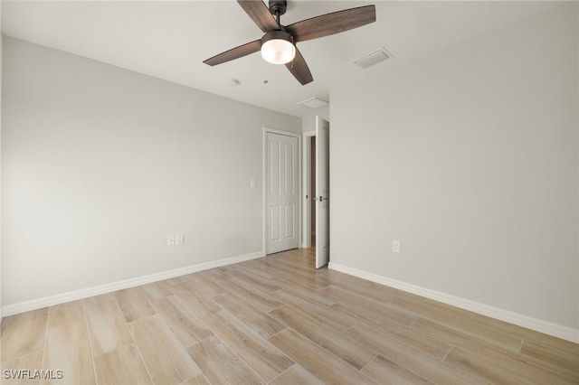 empty room featuring light hardwood / wood-style flooring and ceiling fan