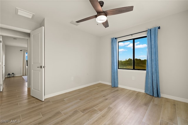 unfurnished room featuring ceiling fan and light wood-type flooring