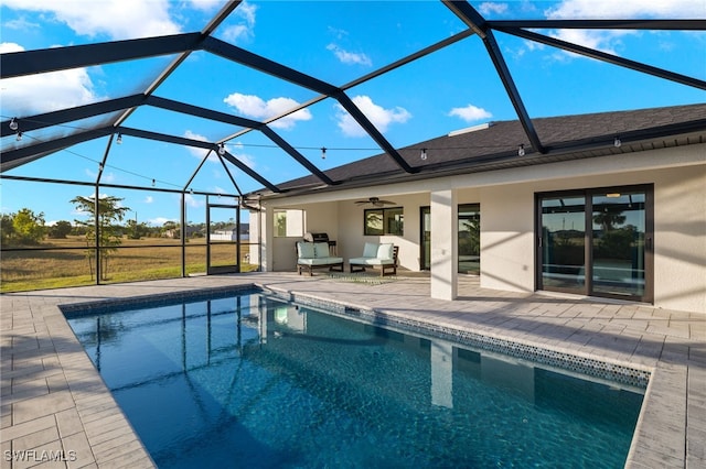 view of pool featuring ceiling fan, a lanai, and a patio