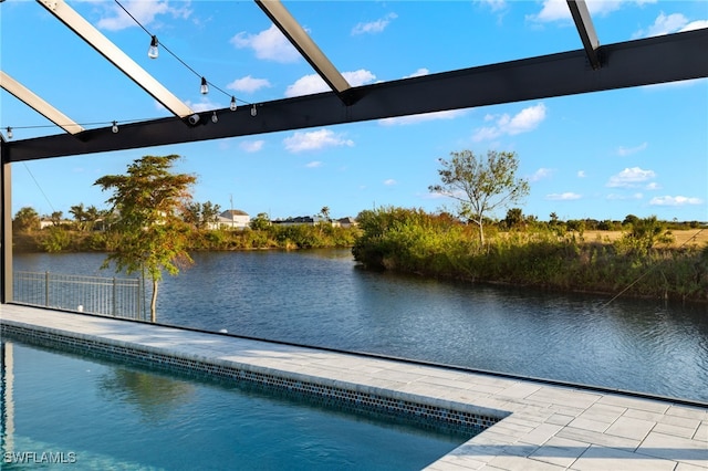 view of swimming pool featuring a patio area and a water view