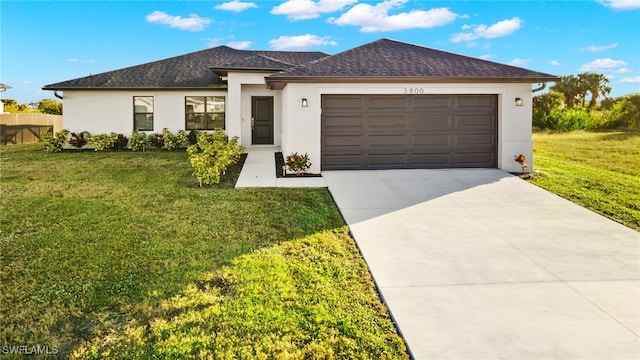 view of front of house featuring a garage and a front lawn