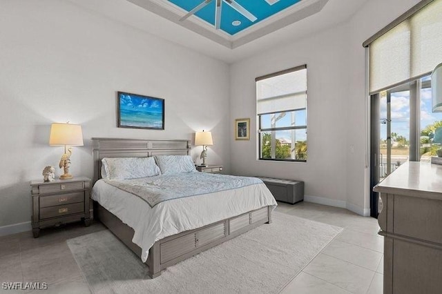 bedroom featuring a raised ceiling and access to exterior