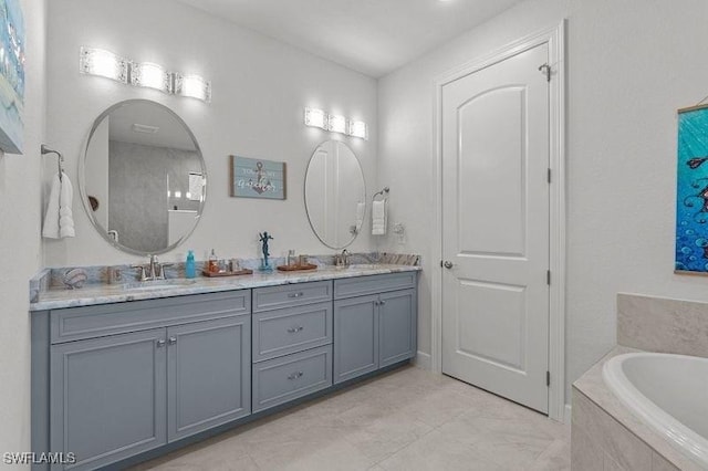 bathroom with tiled bath and vanity