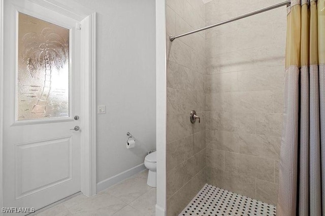 bathroom featuring toilet and walk in shower