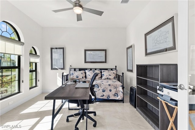 tiled bedroom featuring ceiling fan