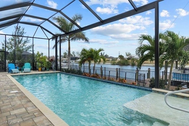 view of swimming pool featuring a water view, a patio area, and a lanai