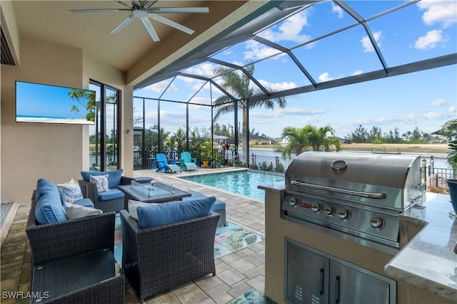 view of patio / terrace featuring an outdoor kitchen, area for grilling, outdoor lounge area, a water view, and glass enclosure