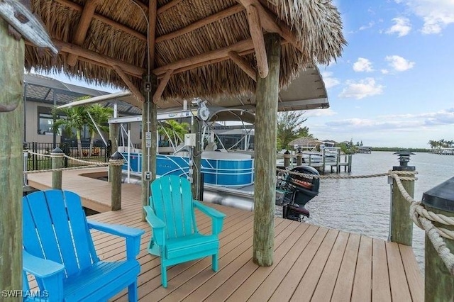 dock area with glass enclosure and a water view