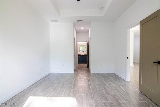 spare room with a tray ceiling