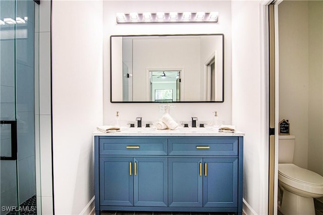 bathroom featuring vanity, an enclosed shower, and toilet