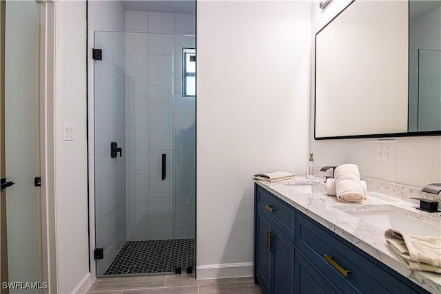 bathroom with vanity and a shower with door