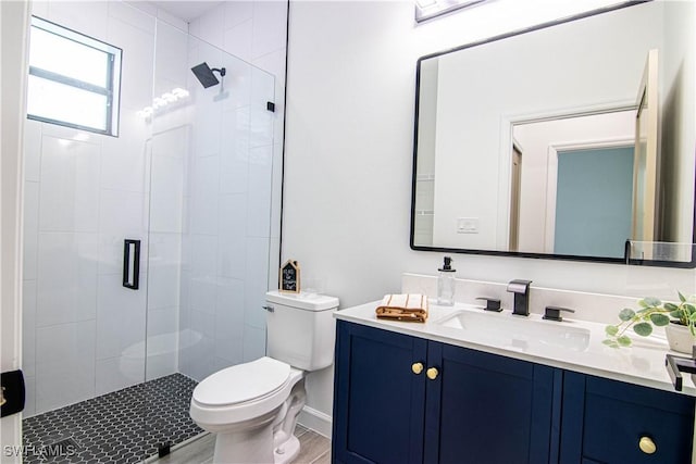 bathroom featuring vanity, an enclosed shower, wood-type flooring, and toilet