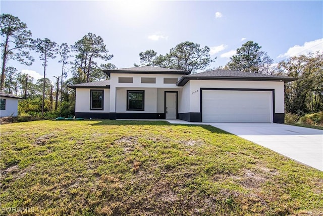 view of front of house featuring a garage and a front lawn