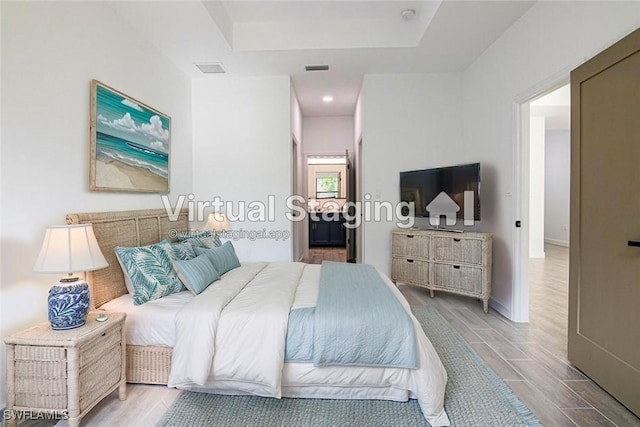 bedroom featuring a raised ceiling