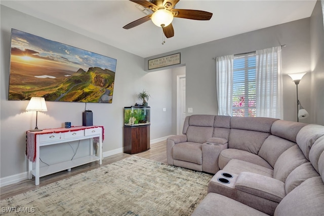 living room with ceiling fan and light hardwood / wood-style flooring