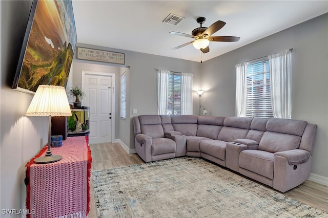 living room with ceiling fan and light wood-type flooring