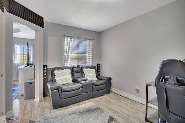 living room with a healthy amount of sunlight and light hardwood / wood-style flooring