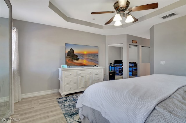 bedroom with ceiling fan and light hardwood / wood-style floors