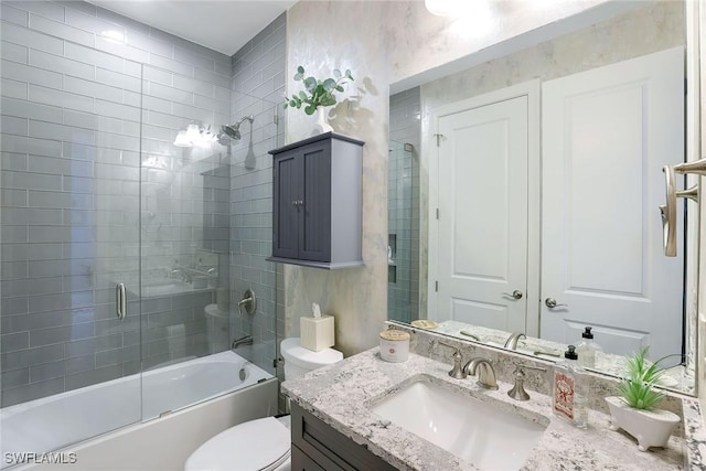 full bathroom with vanity, toilet, and bath / shower combo with glass door