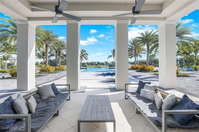 view of patio with outdoor lounge area, ceiling fan, and a water view