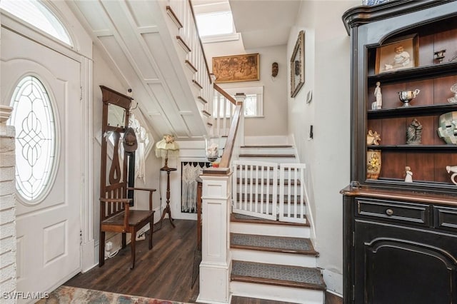 stairs with wood-type flooring and lofted ceiling