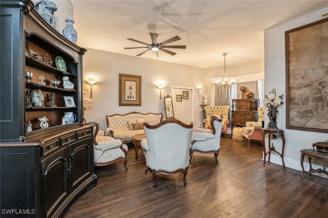 living room featuring ceiling fan with notable chandelier and dark hardwood / wood-style flooring