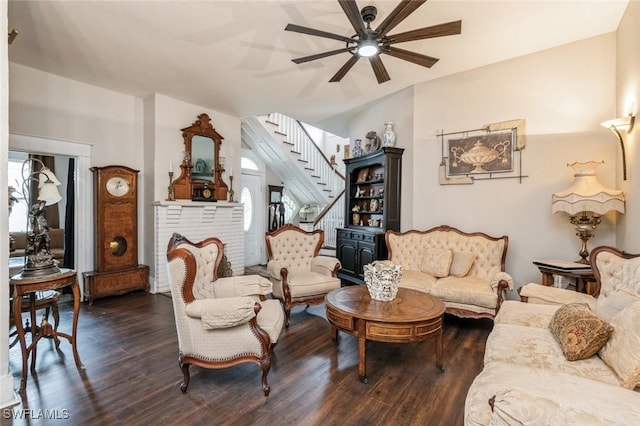 living room featuring ceiling fan and dark hardwood / wood-style flooring