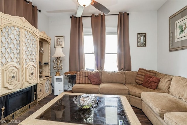 living room with ceiling fan and dark hardwood / wood-style flooring