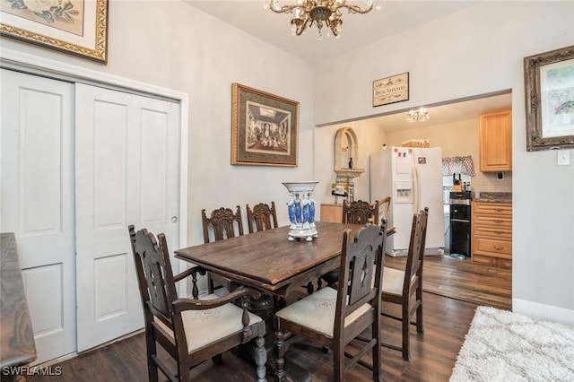 dining room with a notable chandelier and dark wood-type flooring