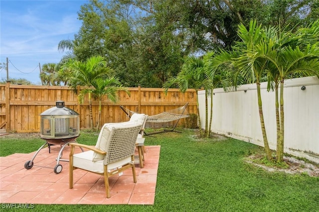 view of yard featuring a patio area and an outdoor fire pit