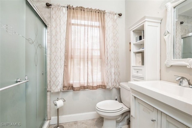 bathroom with vanity, toilet, plenty of natural light, and a shower with shower door