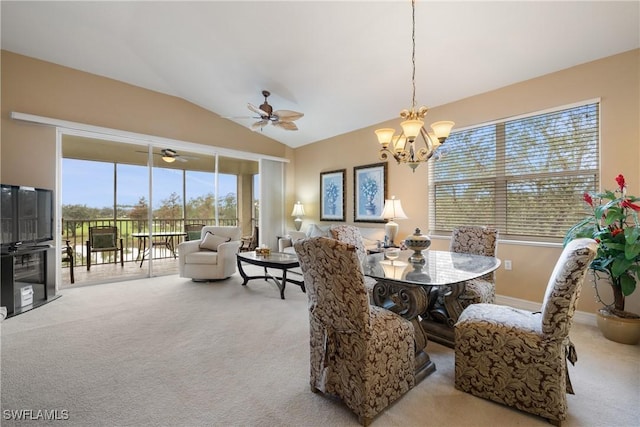 carpeted dining area featuring lofted ceiling and an inviting chandelier