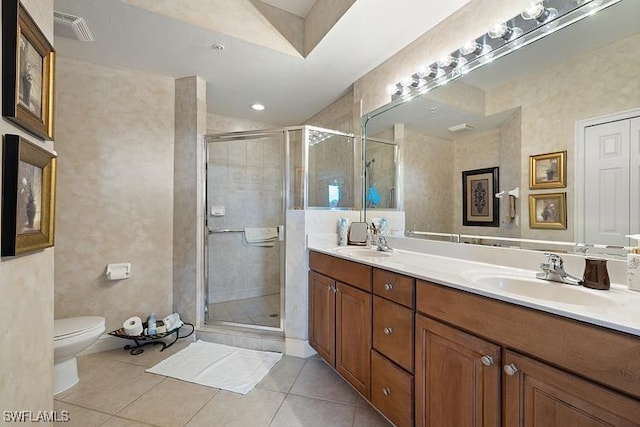 bathroom with toilet, vanity, tile patterned floors, and a shower with shower door