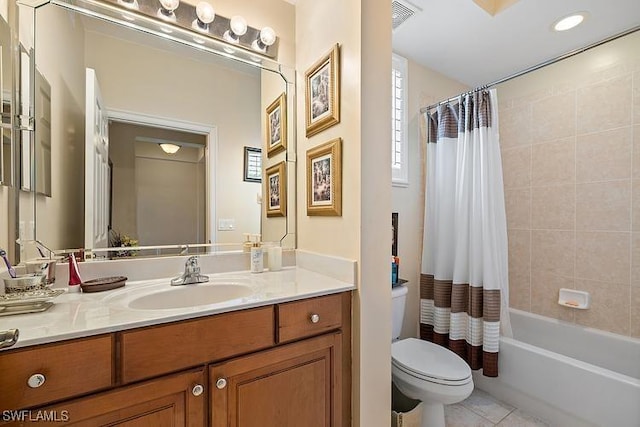 full bathroom featuring tile patterned floors, shower / bath combo with shower curtain, vanity, and toilet