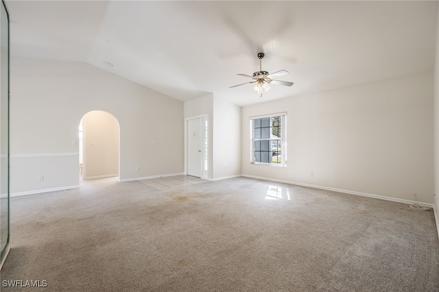 empty room featuring ceiling fan, light colored carpet, and lofted ceiling