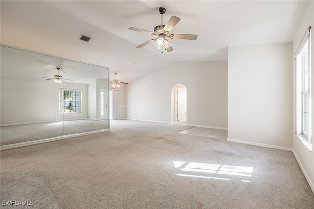 carpeted empty room with ceiling fan and vaulted ceiling