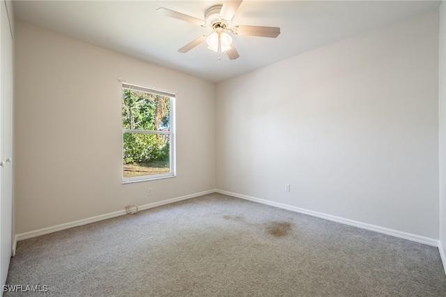 empty room with ceiling fan and carpet