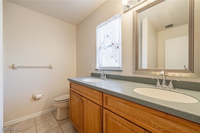 bathroom featuring tile patterned floors, vanity, and toilet