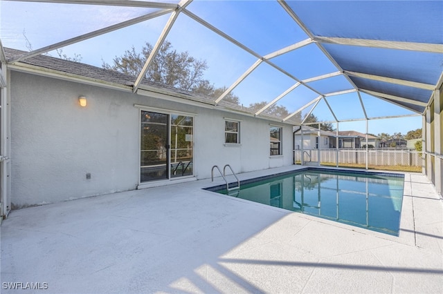 view of swimming pool with a lanai and a patio area