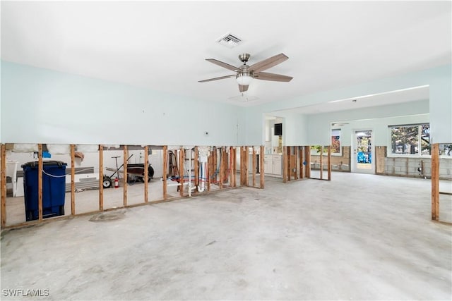 interior space featuring ceiling fan and concrete floors