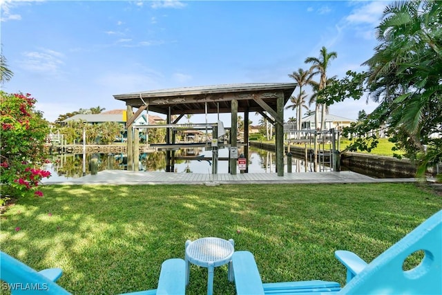 dock area featuring a lawn and a water view