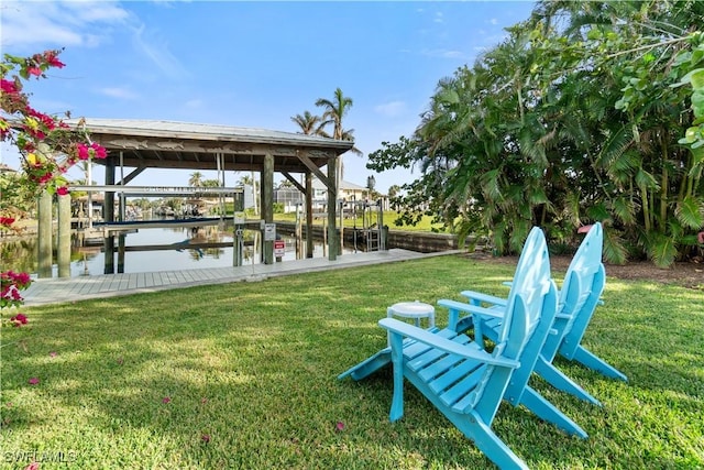 dock area featuring a lawn and a water view