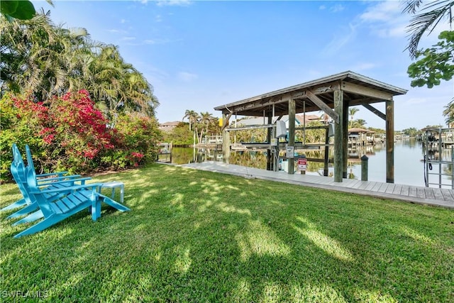 view of yard with a boat dock and a water view