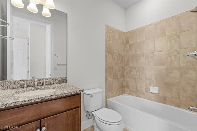 full bathroom with vanity, toilet, and tiled shower / bath