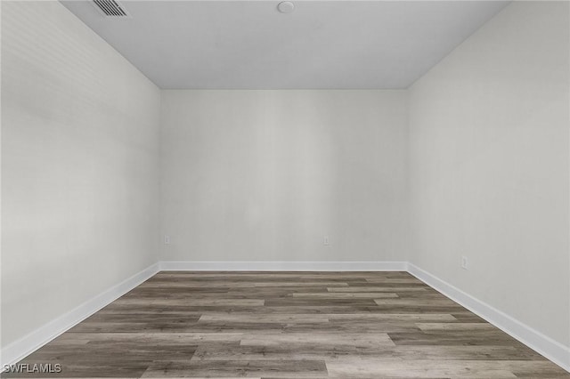 spare room with hardwood / wood-style floors