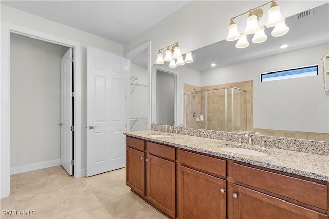 bathroom featuring vanity, tile patterned floors, and an enclosed shower