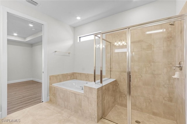 bathroom with hardwood / wood-style floors and independent shower and bath