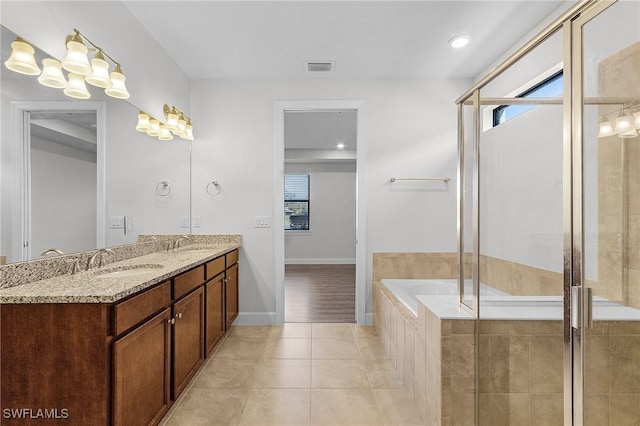 bathroom with vanity, tile patterned flooring, and plus walk in shower