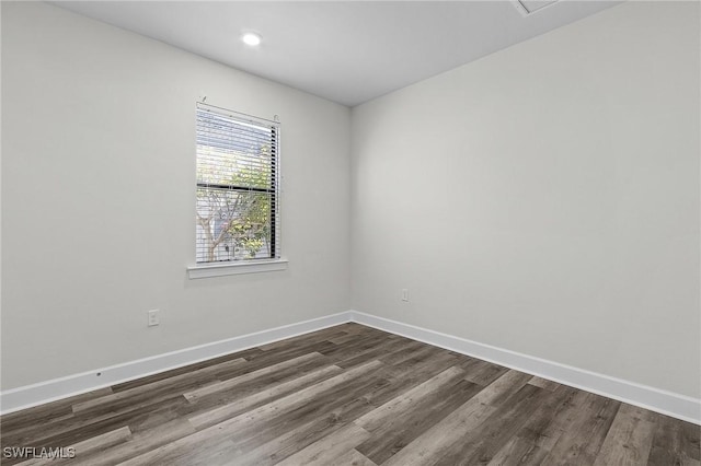 unfurnished room with dark hardwood / wood-style floors